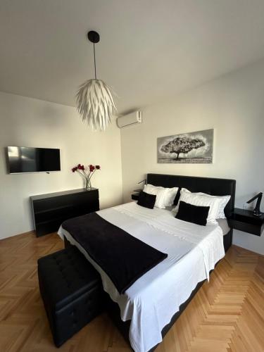 um quarto com uma cama grande e uma luz pendente em Stunning apartment Josipa em Kaštela