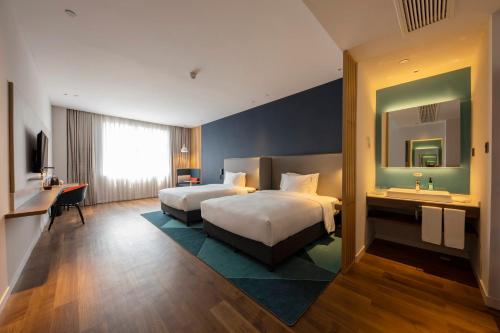 Postel nebo postele na pokoji v ubytování Holiday Inn Express Shanghai Jiading New City by IHG