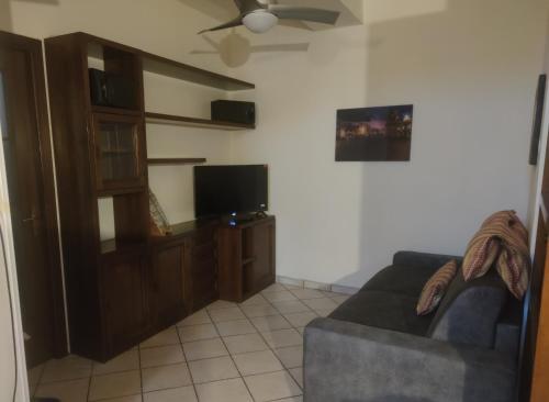 a living room with a couch and a flat screen tv at La Dimora del Borgo in Pinerolo