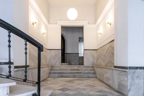 a hallway of a building with stairs and a window at Couple-in magical suite with jacuzzi in Thessaloniki