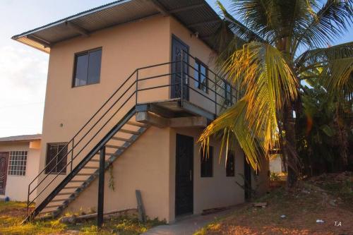 a house with a staircase on the side of it at San Juan Loft in Santiago