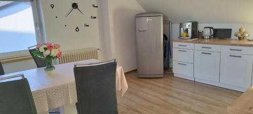 a kitchen with a table and a refrigerator at Ferienwohnung Fabian in Stainach