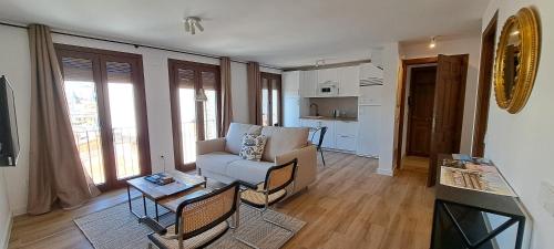 a living room with a couch and a table at Apartamentos Callejón de Recogidas 2 in Toledo