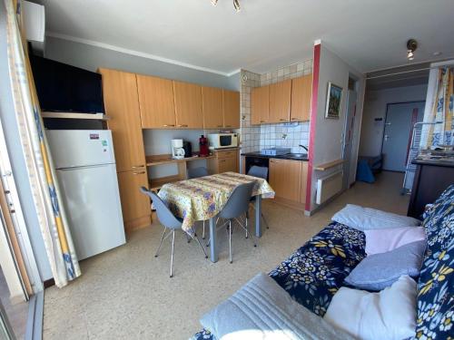 - une petite cuisine avec une table et un lit dans l'établissement Appartement cosy avec climatisation, WIFI à 5 min des Thermes - Animaux admis - FR-1-503-26, à Balaruc-les-Bains