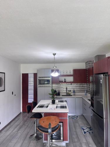 a kitchen with white cabinets and a table and chairs at Liberia vacational condo in Liberia