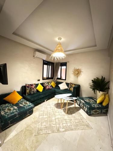 a living room with couches and a table at Cosy & magnifique appartement Marrakech in Marrakech
