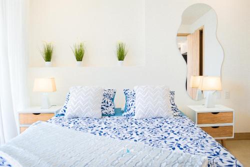 a bedroom with a bed and a mirror and plants at Apartamento vista al Mar lateral Panoramic View,Spectacular building,Pools, Beach Morros zoe ultimo piso in Cartagena de Indias