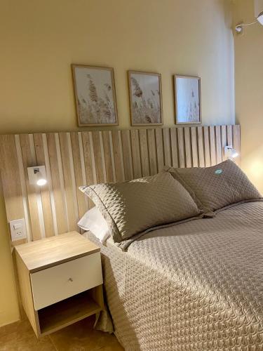 a bedroom with a bed with a wooden headboard at Chill Home IV in Posadas