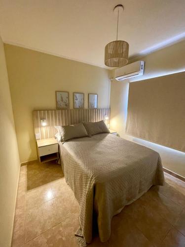 a bedroom with a large bed and a nightstand and a bed sidx sidx sidx at Chill Home IV in Posadas