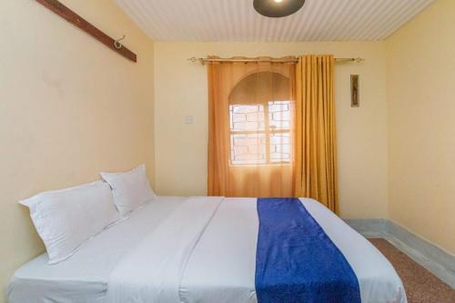 a bedroom with a large bed and a window at City Space Hotel in Nairobi