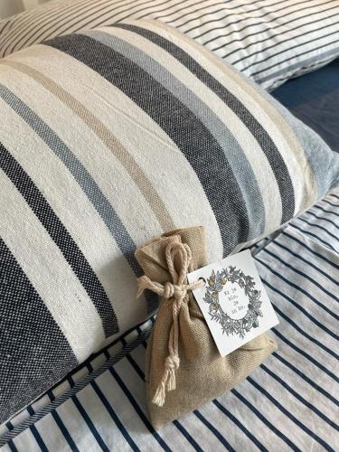 a pillow with a tag on it on a bed at Villa Kata in Rab