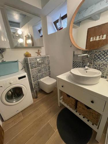 a bathroom with a washing machine and a sink at Villa Kata in Rab