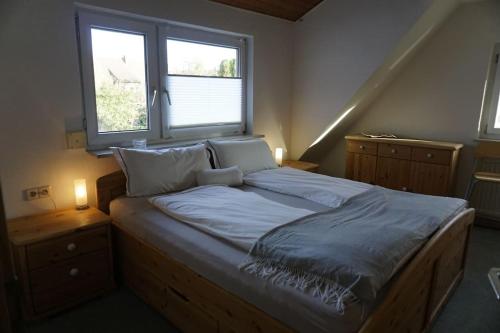 a large bed in a bedroom with a window at Apartment Christina in Weingarten