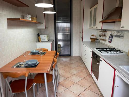 a kitchen with a wooden table and some chairs at Burago Flat in Burago di Molgora