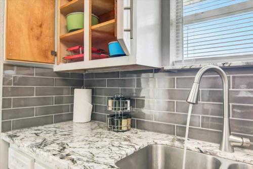 a kitchen with a sink and a counter top at Comfy 3 bedroom home w/ fenced yard in Bridge City