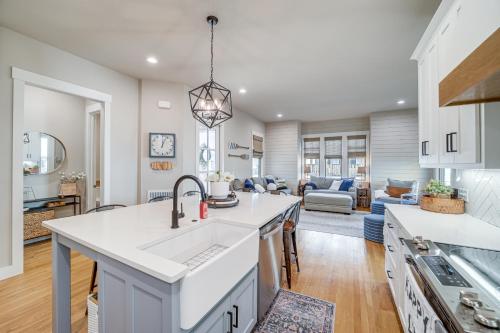 a kitchen and living room with white cabinets and a sink at Cozy Carlton Landing Home - Pools and Lake Access in Canadian
