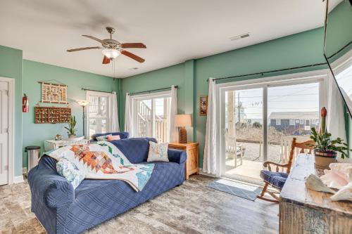 a living room with a couch and a ceiling fan at Ocean-View Apt in Emerald Isle - Walk to Beaches! in Emerald Isle