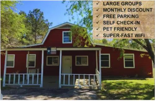 a red house with a sign in front of it at Pure Country, plenty of space & trees, relaxing! in Lumberton