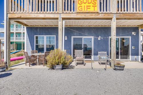 a building with a table and chairs in front of it at Ocean-View Apt in Emerald Isle - Walk to Beaches! in Emerald Isle