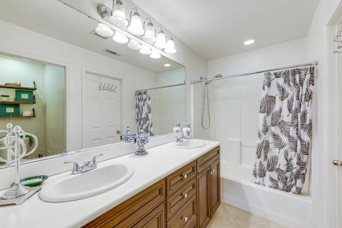 a bathroom with two sinks and a mirror and a tub at Oxnard Vacation Rental about 2 Mi to Beach! in Oxnard