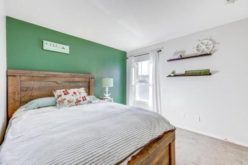 a bedroom with a bed and a green wall at Oxnard Vacation Rental about 2 Mi to Beach! in Oxnard