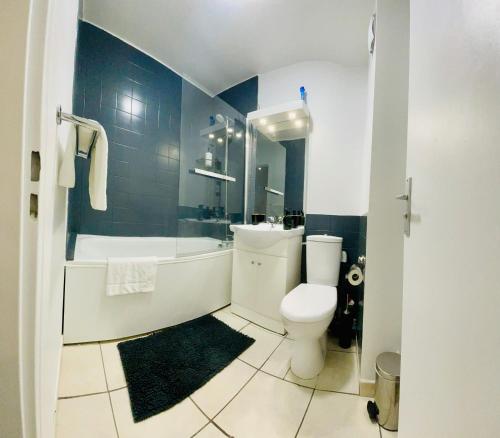 une salle de bain avec toilettes, baignoire et lavabo dans l'établissement Studio Rénové au calme avec Terrasse Trouville, à Trouville-sur-Mer
