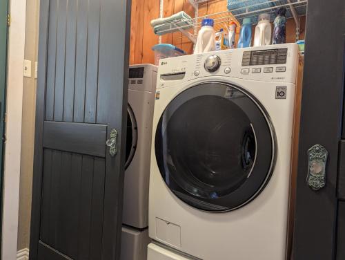 a washing machine sitting next to a door at Robbins Nest in South Toledo Bend