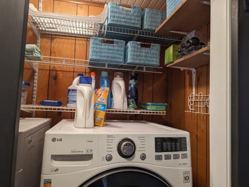 a washing machine with cleaning products on top of it at Robbins Nest in South Toledo Bend