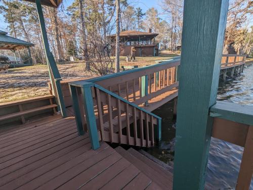 a wooden deck with a gazebo on the water at Robbins Nest in South Toledo Bend