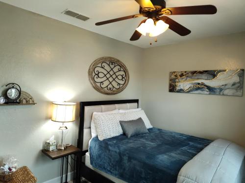 a bedroom with a bed and a ceiling fan at Buena Vista home in Visalia