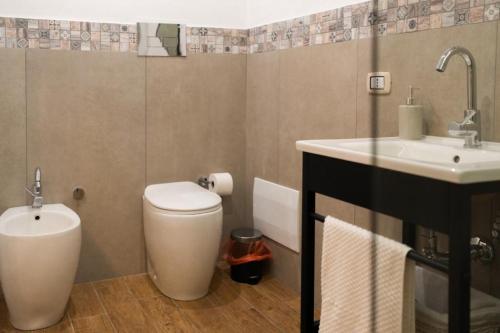 a bathroom with a toilet and a sink at Le Casine di Spaccanapoli in Naples