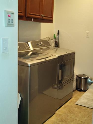 a kitchen with a stainless steel stove top oven at Buena Vista home in Visalia