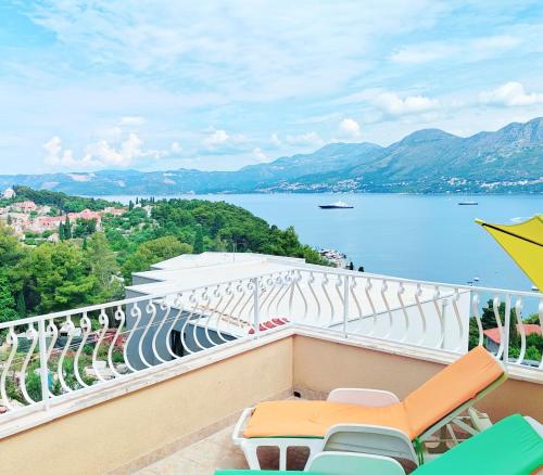 a balcony with chairs and a view of the water at Villa Stanović Tea in Cavtat
