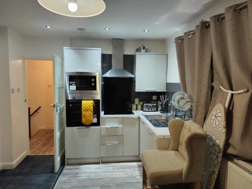 a kitchen with a sink and a stove at Garden of peace in Erith