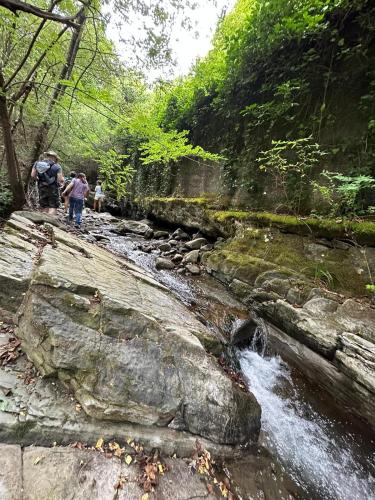 a group of people walking along a river at Villa il Vecchio Abete in Raccuia
