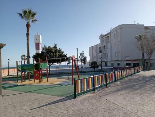 a park with a playground with a swing at Apartamento Aimar Barbate in Barbate