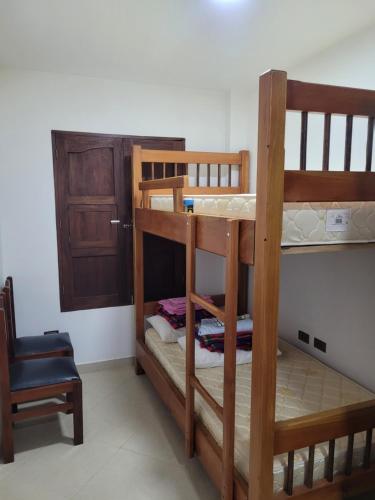 two bunk beds in a room with a door at Apartamento en Jardín-Antioquia in Jardin
