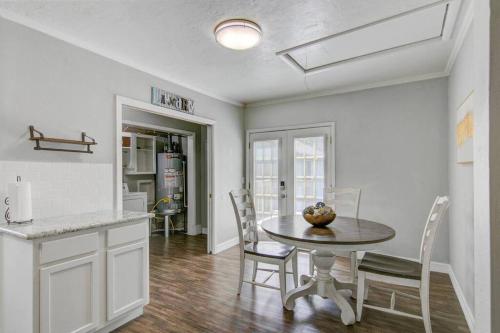 a kitchen and dining room with a table and chairs at Spacious 3 bedroom home with fenced yard in Groves