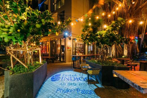 an outdoor restaurant with tables and chairs and lights at Hotel Indigo Phuket Patong by IHG in Patong Beach