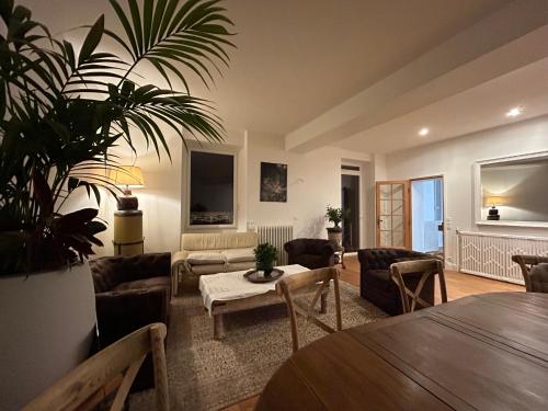 a living room with a couch and a table at L'Escale de Beauregard in Coublevie