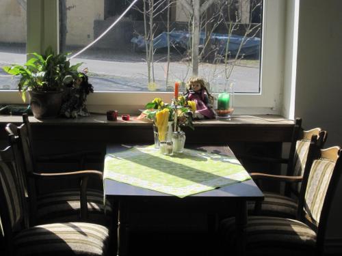 a table in a room with a window at Gasthaus Rogge in Lemgo