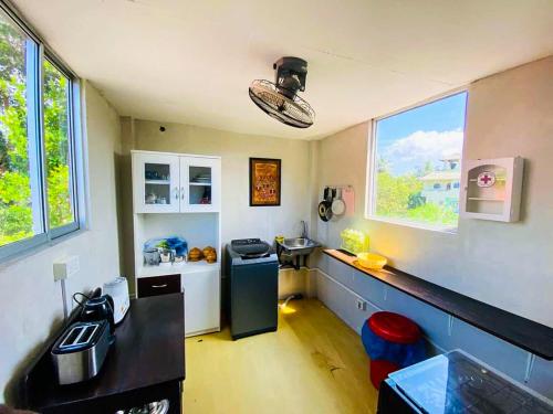 a kitchen with a counter and a sink in a room at OVIYA Guest & Rest in Weligama