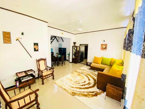 a living room with a couch and a table at OVIYA Guest & Rest in Weligama