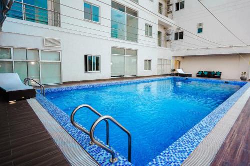 a large swimming pool in a building at Two-Bedroom Luxury Apartment, Zameen Opal in Lahore