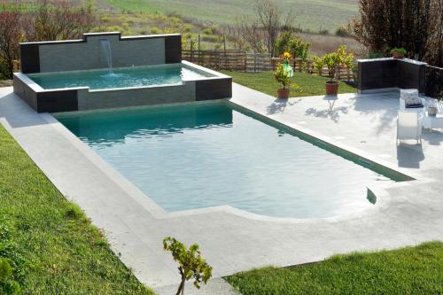 a swimming pool in the middle of a yard at Casale Santomanno in Aquasparta