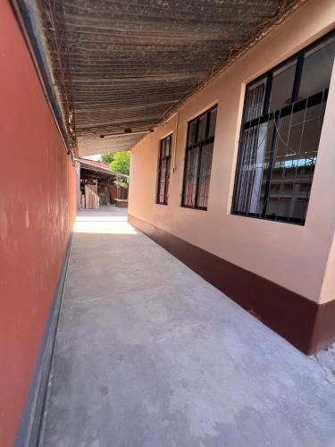 an empty hallway of a building with windows at Casa Amigable y Confortable in Yacuiba