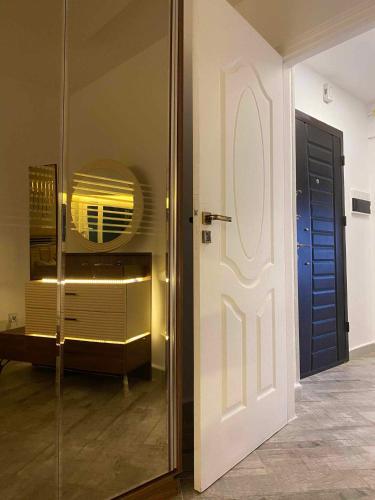 a door leading into a room with a mirror at bejaia room in Bejaïa