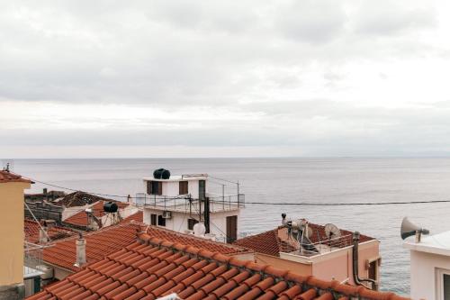 a view of the ocean from the roofs of buildings at Jano's House in Plomari
