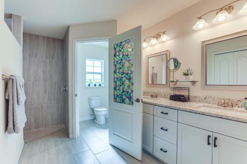 a bathroom with a sink and a toilet and a mirror at Beautiful Venice Getaway, 4 Mi to Manasota Beach! in Venice