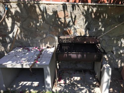 a bench sitting in front of a stone wall at Hotel El Molle in Lunahuaná